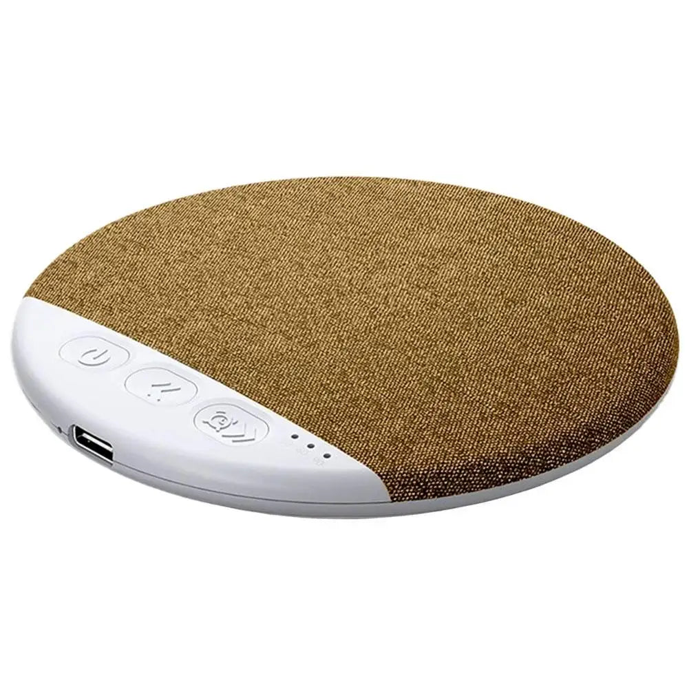 Round, bronze fabric-covered wireless under-pillow speaker with white control panel, buttons and charging port.