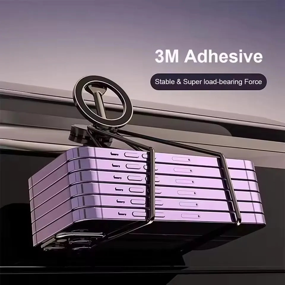 Black adhesive magnetic phone holder mounted on a surface, supporting a heavy stack of purple smartphones.