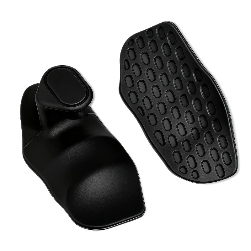 Black ergonomic scalp massager with a curved handle and a textured, oval-shaped base with rubberised bristles.