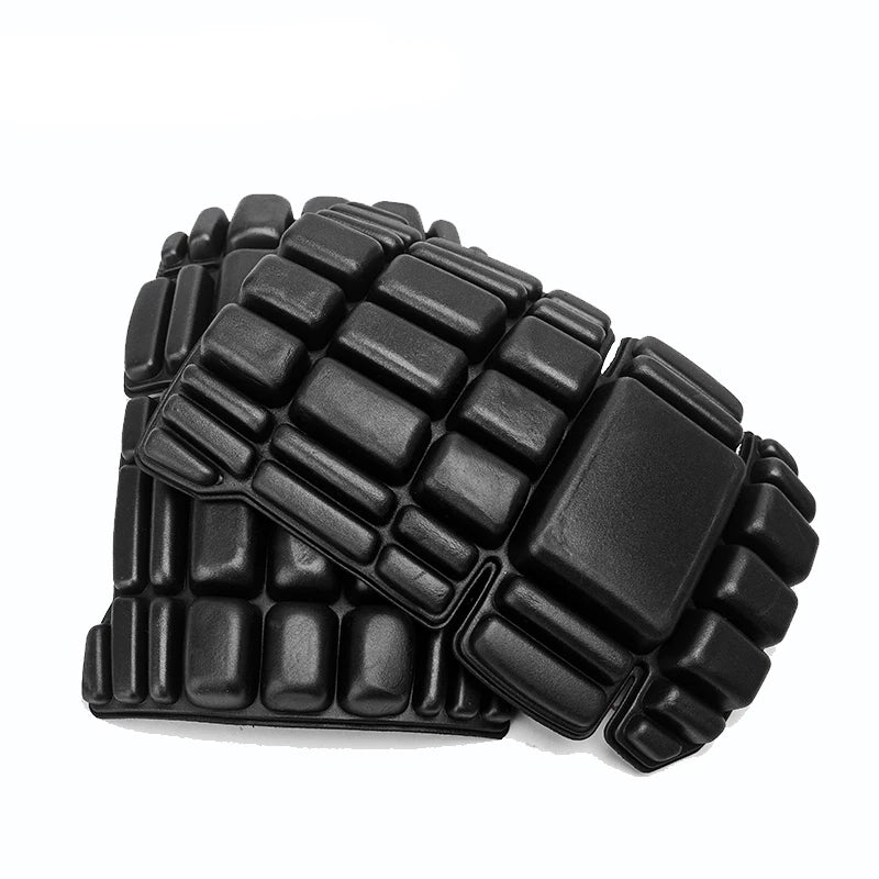 A pair of black, rectangular foam knee pads with a segmented, grid-like protective design.