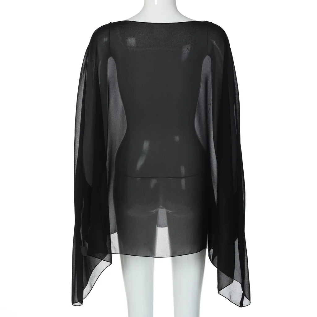Sheer black chiffon poncho-style cover-up with a loose, flowing silhouette and a straight hemline on a mannequin.