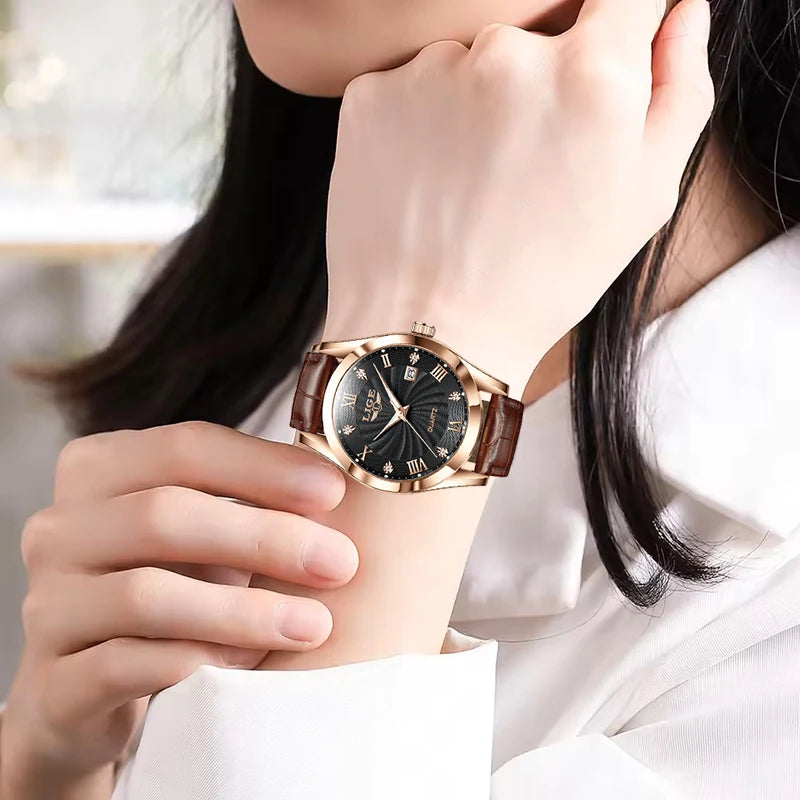 Elegant women's watch with a rose gold case, black dial with Roman numerals, and a brown leather strap.