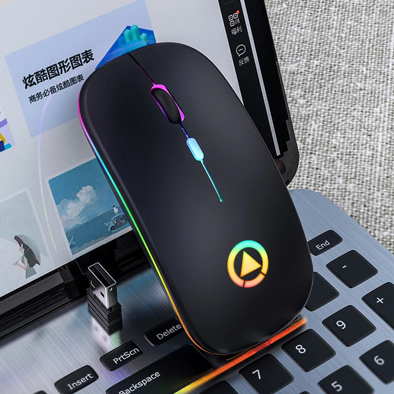 Sleek black wireless mouse with rainbow RGB lighting, ergonomic design, and USB receiver, resting on a laptop keyboard.