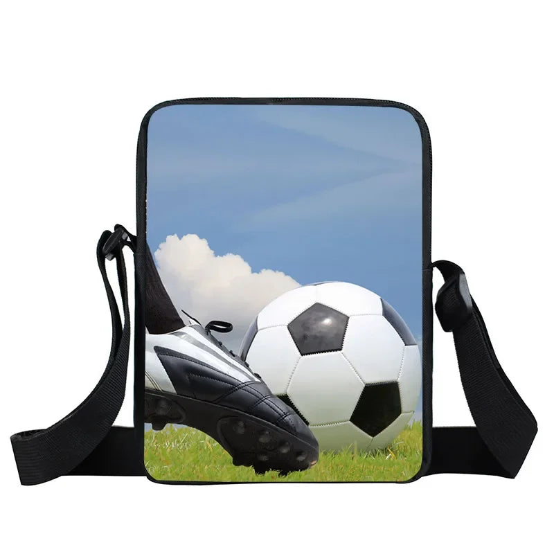 Crossbody shoulder bag with a football pitch print, showing a boot kicking a football, with black adjustable strap.