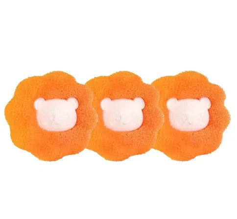 Three orange, flower-shaped bath sponges, each featuring a cute, white bear-shaped centre.