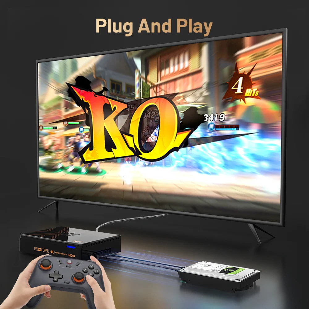 Black Kinhank Super Console X5 PRO connected to a TV showing a fighting game, with a gray controller and hard drive.