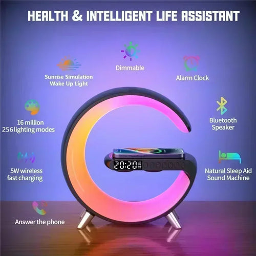 Black G-shaped wireless charging stand with LED alarm clock, Bluetooth speaker, and multicoloured ambient lighting.