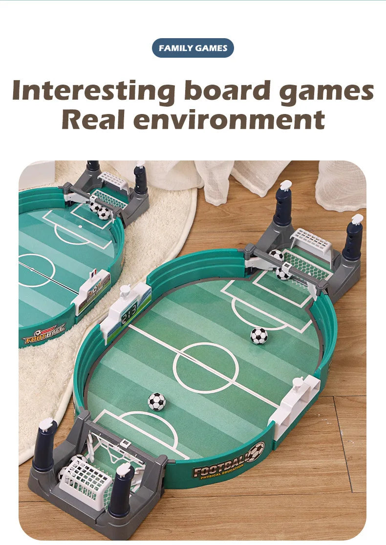 Tabletop football game featuring an oval green pitch, goal nets, and small monochrome footballs for two-player action.