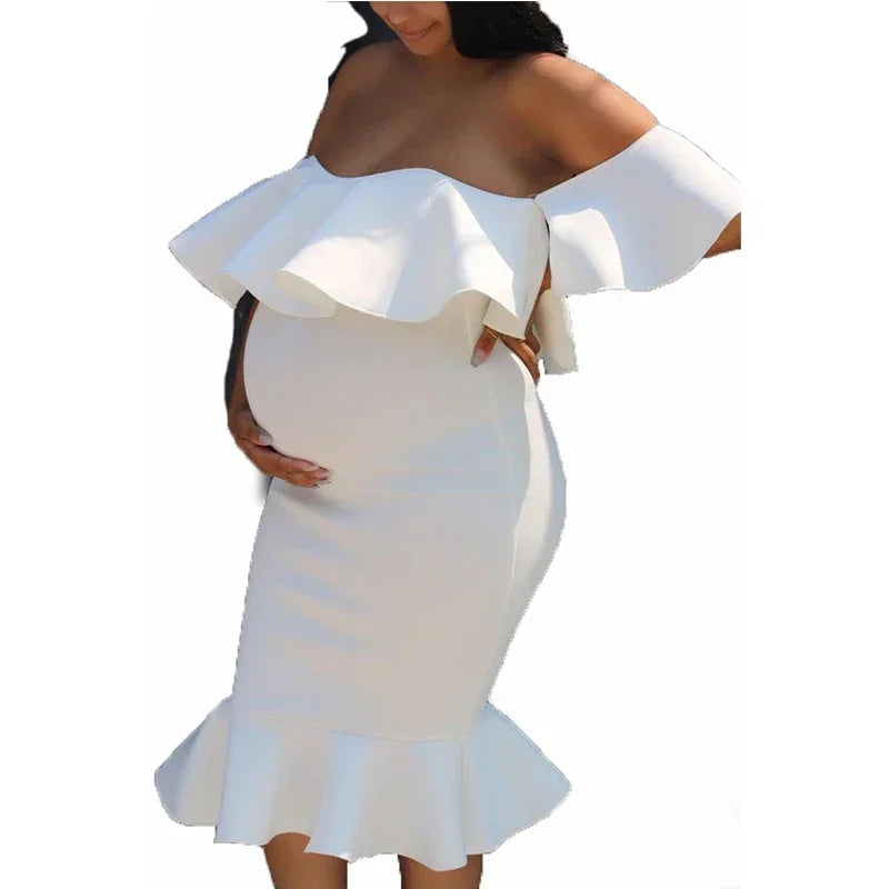 White maternity midi dress with an off-the-shoulder ruffled bodice and a flared mermaid hem.