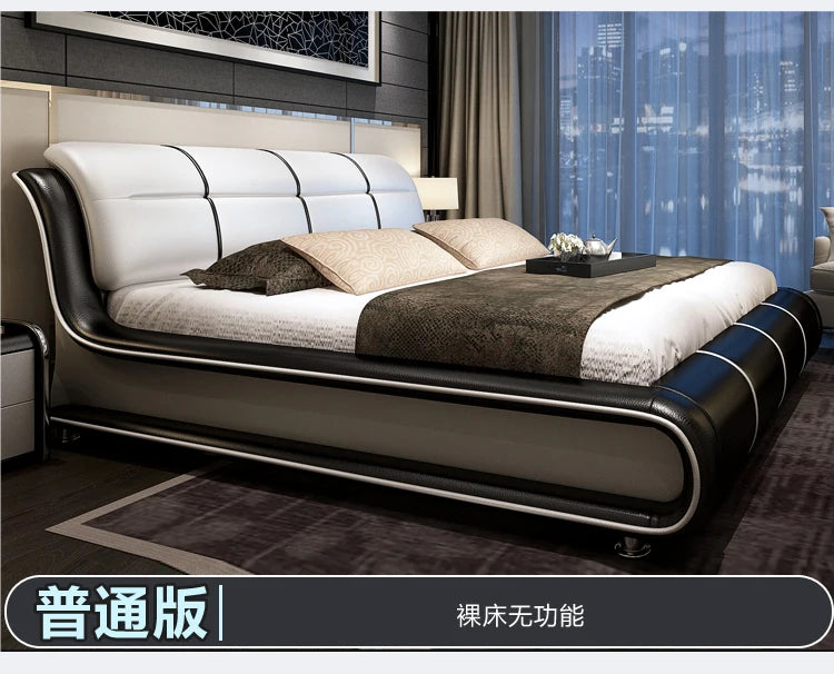 Modern cream and black leather bed frame with a sleek, curved design and panelled headboard.