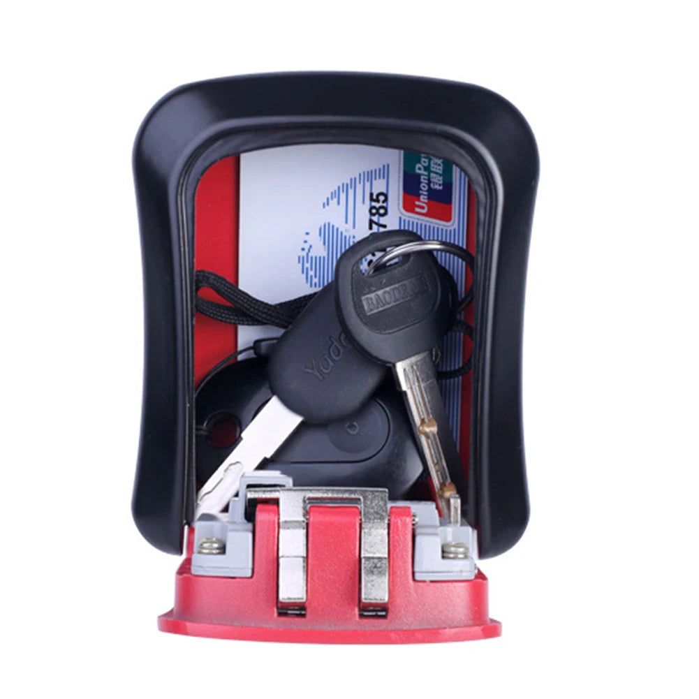Open red and black plastic key lock box containing keys and a card against a white background.
