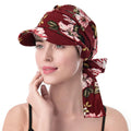 A burgundy headscarf hat with a pink floral print, featuring a stiff brim and a tie-back design.