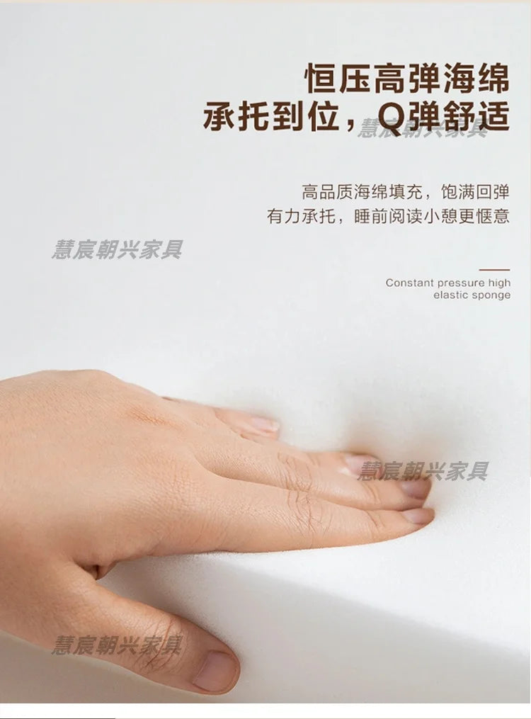 A close-up of a hand pressing into white, high-density elastic sponge padding for a modern leather bed frame.