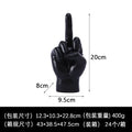 Black sculptural ornament shaped like a hand making a rude gesture, measuring 20cm high. Smooth matte finish.