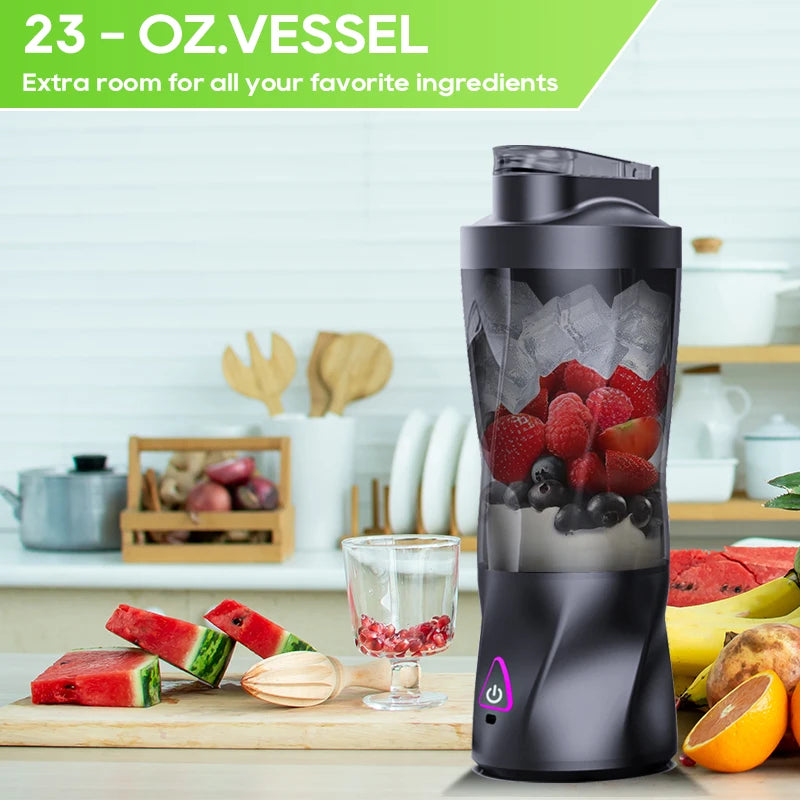 Black portable personal blender containing ice and mixed berries, sitting on a kitchen counter.