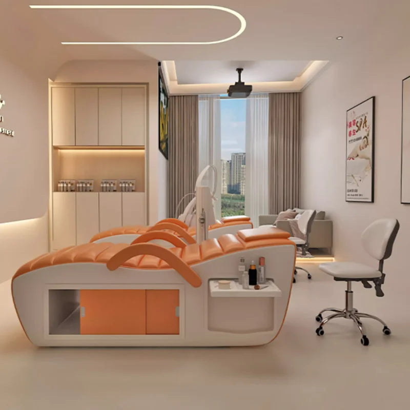 Modern orange and white professional massage bed featuring a sleek design with built-in side storage and shelving.