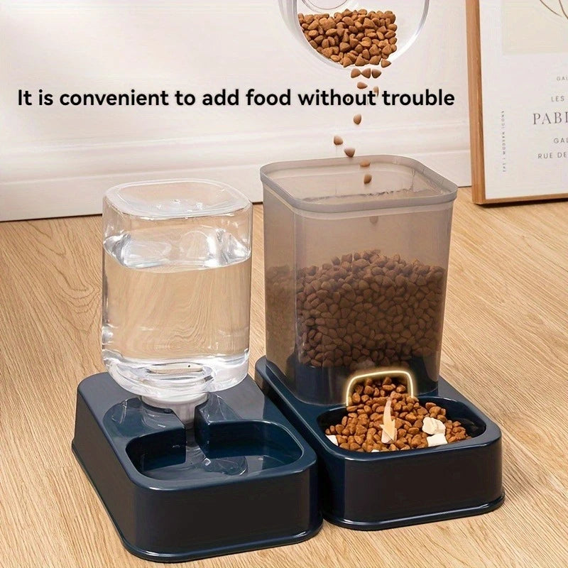 Dark blue pet feeder and water dispenser set with clear containers, shown being filled with dry food on a wood floor.