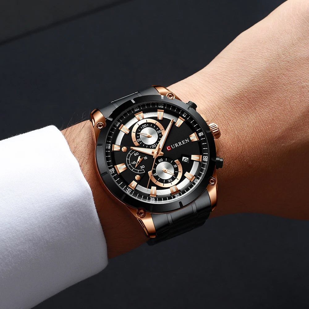 Luxury men’s watch with a black and rose gold stainless steel strap, black face, chronograph dials and date window.