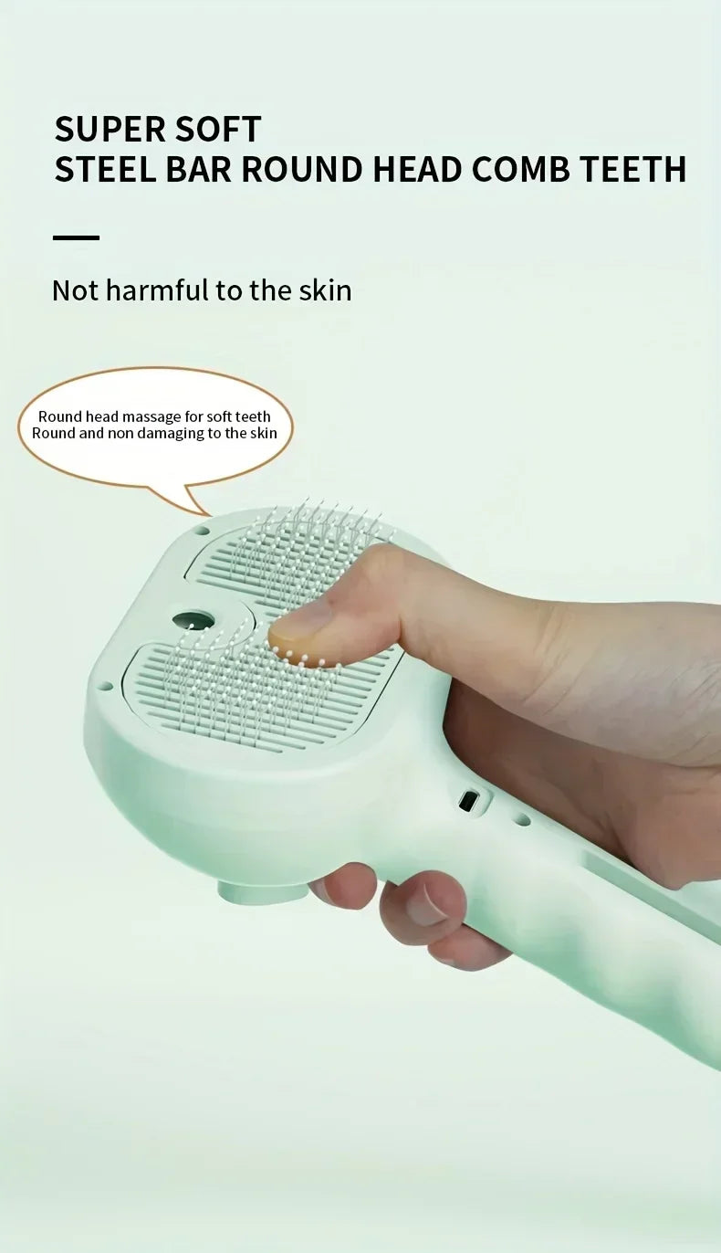 A hand holding a pale green pet grooming brush with soft, round-tipped steel bristles.