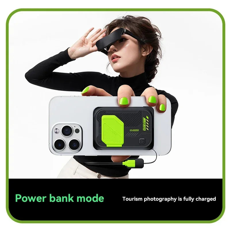 Black and lime green magnetic wireless power bank with an integrated fold-out stand, attached to a smartphone.