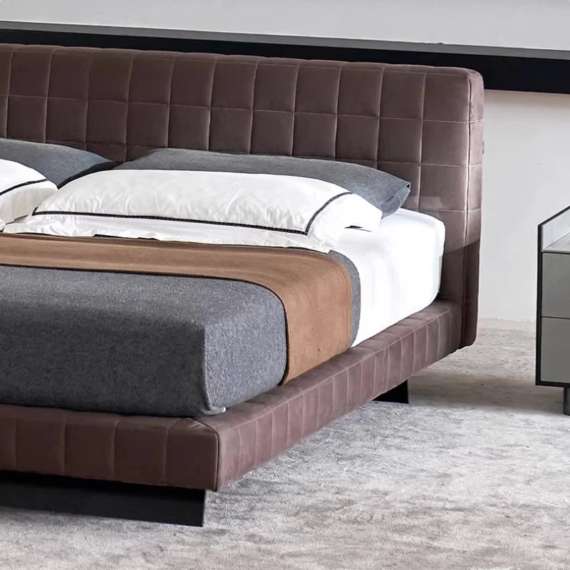 Modern Nordic bed frame in brown upholstered fabric, featuring a grid-stitched headboard and sleek low-profile design.