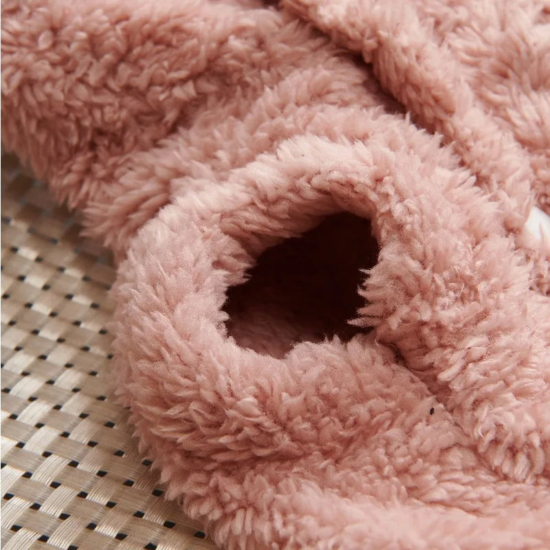 Soft pink fleece dog hoodie, focusing on the fuzzy texture and sleeve opening.