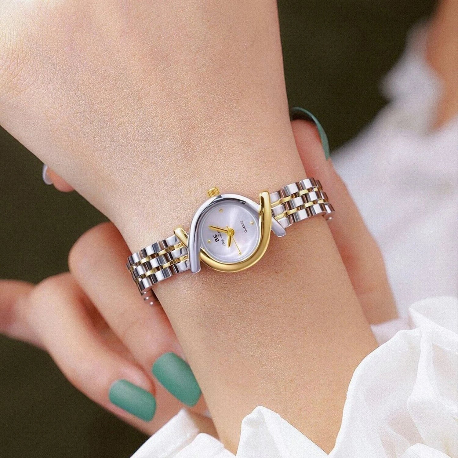 Elegant women's quartz watch featuring a two-tone silver and gold stainless steel link strap and circular face.
