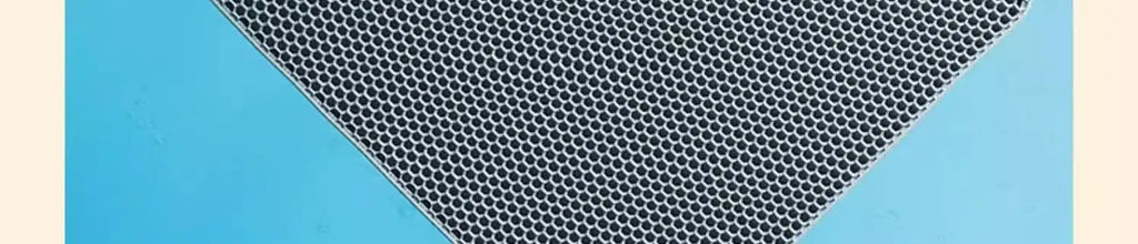 Grey heavy-duty cat litter mat with a honeycomb texture design, set against a bright blue background.