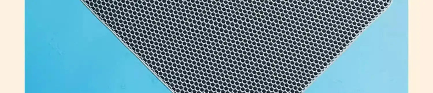 Grey heavy-duty cat litter mat with a honeycomb texture design, set against a bright blue background.