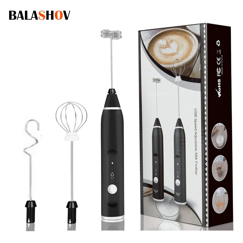 Handheld black electric milk frother with three interchangeable stainless steel whisk attachments and gift box.