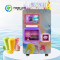 Pink slush vending machine with touchscreen, raised cup placement tray, and edge baffle to prevent overflow.