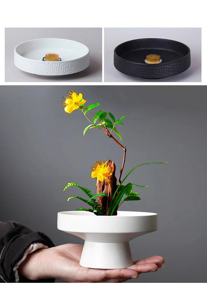 Round textured ceramic ikebana flower vase with internal pin frog, available in matte white or black.