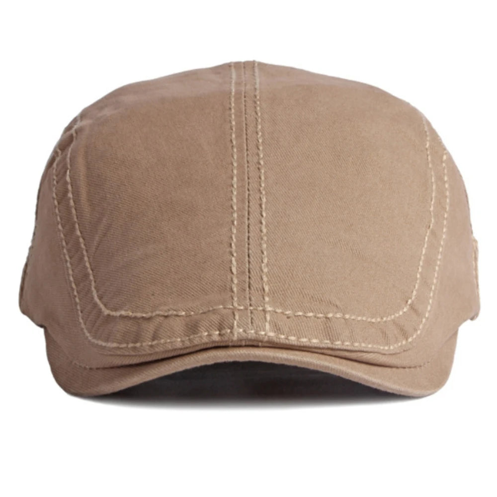 A plain beige cotton flat cap with structured panel stitching, viewed from the front.