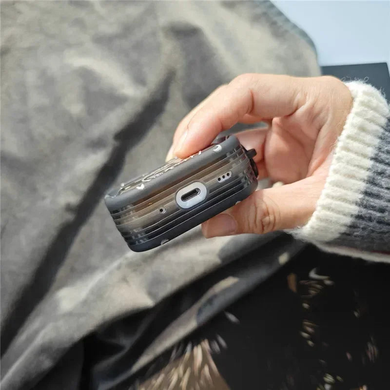 Black translucent silicone AirPods Pro case with speaker cutouts, held in a hand.
