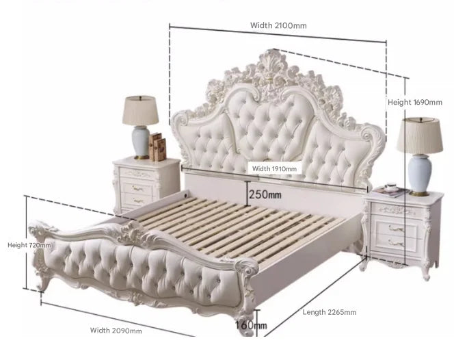 Luxury white princess bed with an ornate, button-tufted headboard and matching bedside tables, featuring carved details.