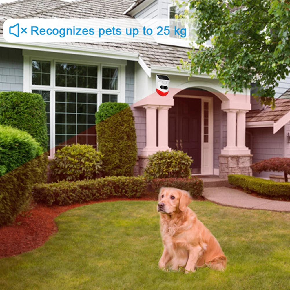 White, solar-powered wireless motion security alarm mounted on a house exterior; pet-friendly up to 25kg.