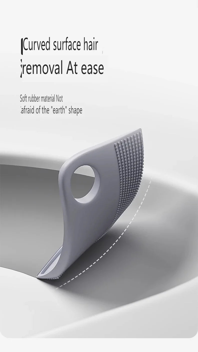 Grey, flexible rubber hair removal tool with a textured grip and finger hole for curved surfaces.