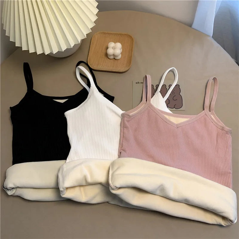 Three ribbed camisole tops in black, white, and pink, each featuring a soft, fleece-lined interior and V-neckline.
