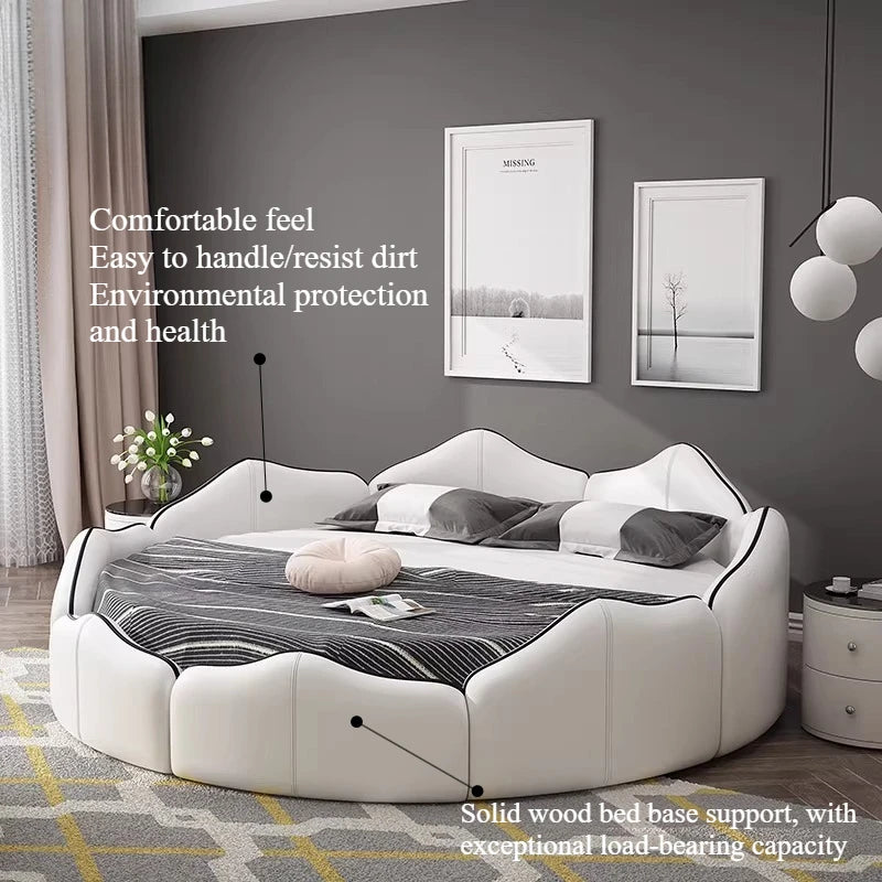 A luxury white, circular upholstered bed frame with a sculpted, petal-like headboard and black trim detail.