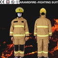 Tan aramid firefighter suit with reflective stripes, black knee pads, and a matching yellow safety helmet.