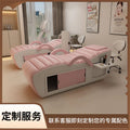 Professional pink and white massage bed featuring integrated storage cabinets and an attached side tray for accessories.