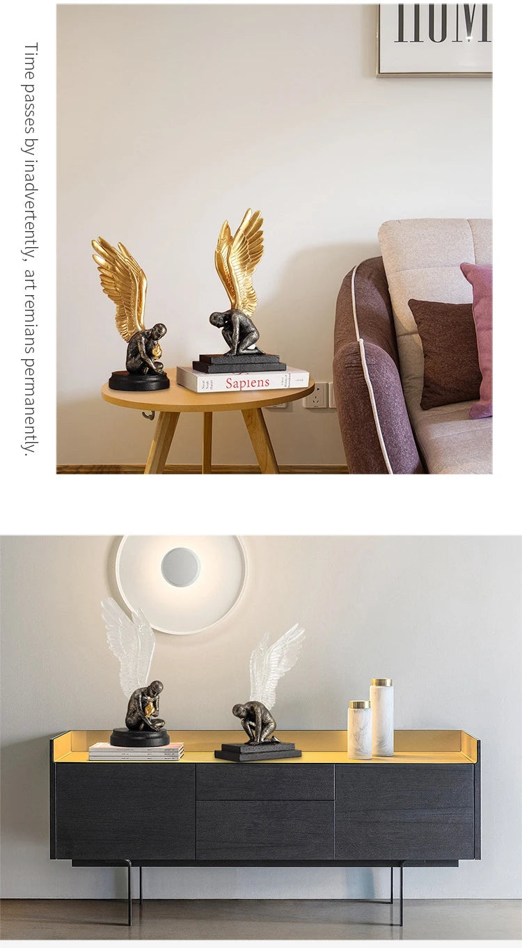 Two decorative resin statues of kneeling figures with detailed angel wings in gold or clear styles on black bases.