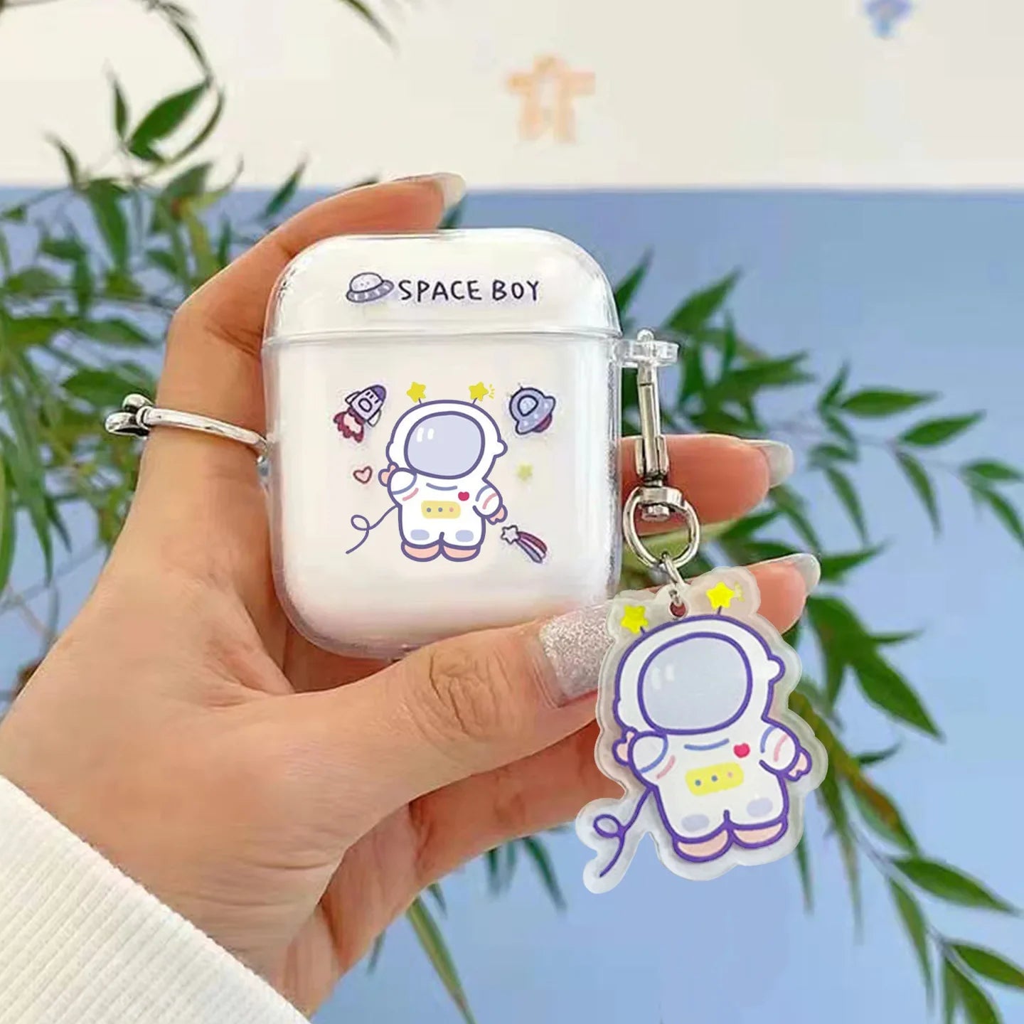 Clear protective case for AirPods with Space Boy astronaut print and matching charm.