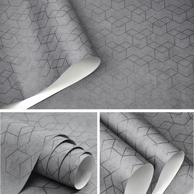 Wallpaper roll in a modern grey finish, featuring a subtle geometric cube pattern with a textured, matte effect.